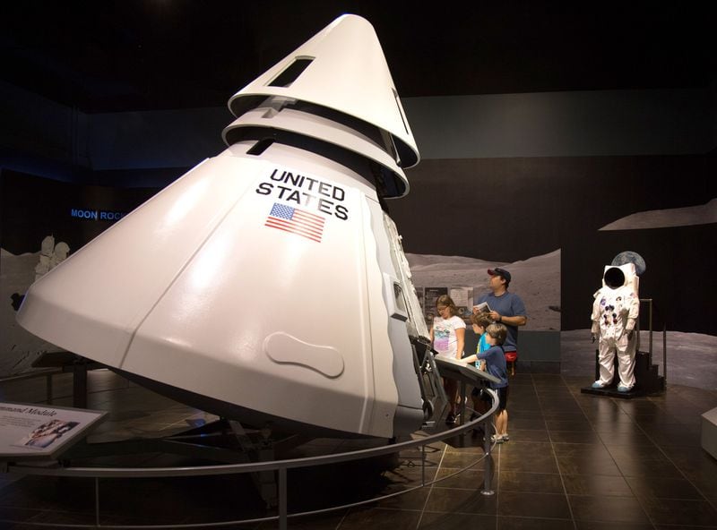 A family looks over a replica of the Apollo 1 capsule at the Tellus Science Museum in Cartersville in this 2015 file photo. STEVE SCHAEFER / SPECIAL TO THE AJC