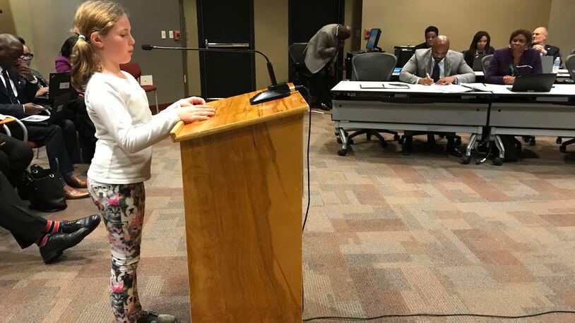 Falyn Handley, 10, a fifth grader at Springdale Park Elementary School, wears dog-print leggings while she addresses the Atlanta Board of Education on Monday to ask for an update to the district's student dress code policy. She collected more than 1,000 signatures on an online petition.