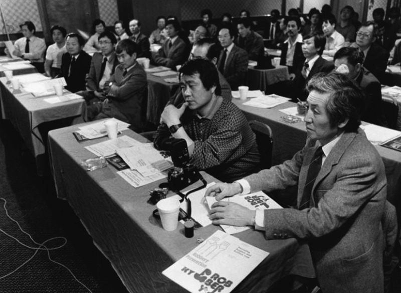 Korean businessmen listen to local police give crime prevention tips in a Sunday session in 1986. (Bill Mahan / AJC Archive at GSU Library AJCP159-043a)