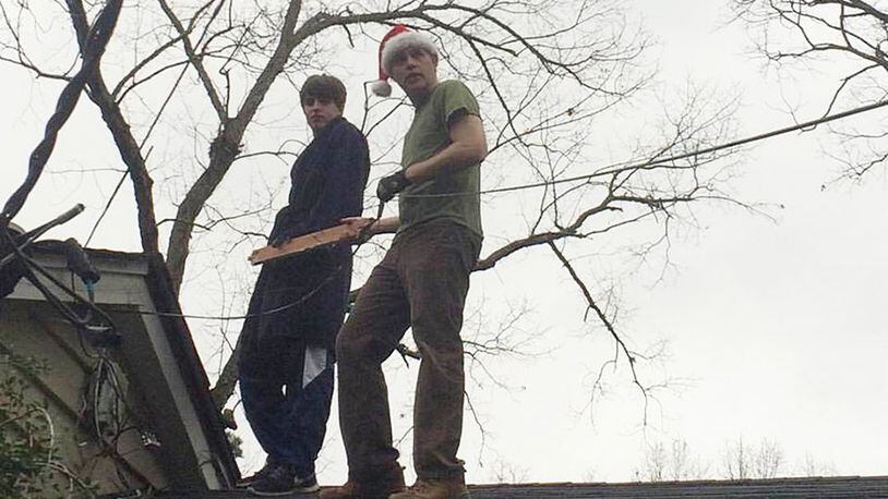 Thornton Kennedy II (in the Santa hat) of Atlanta and his son Thornton spent Christmas Day up on the rooftop ... addressing wires tossed about during Christmas Eve storms.