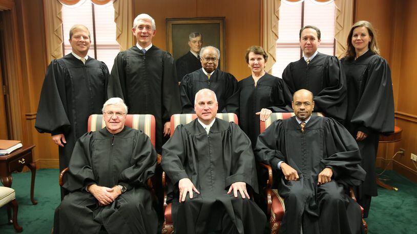 Superior Court Judge Eric Norris (front row, center), when he sat as a visiting state Supreme Court justice because another justice had a conflict of interest. First row (from left to right): then-Chief Justice Harris Hines, Norris and former Justice Harold Melton. Back row (left to right): Justices Nels Peterson and David Nahmias and former Justices Robert Benham, Carol Hunstein, Keith Blackwell and Britt Grant. (Photo: Judgenorris.com)