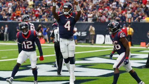 Texans rookie quarterback Deshaun Watson celebrates with Bruce Ellington #12 and Lamar Miller #26 after scoring on a one-yard run in the second quarter against the Titans at NRG Stadium on Sunday in Houston.