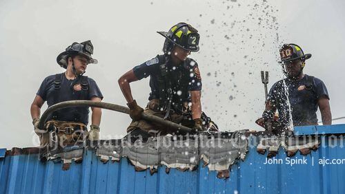 Atlanta fire crews worked to put out two fires on the roof of a vacant structure on Conley Road on Wednesday morning.