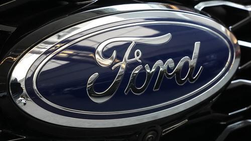FILE - The Ford logo is seen on the grill of a Ford Explorer on display at the Pittsburgh International Auto Show in Pittsburgh, on Feb. 15, 2024. Two fatal crashes involving Ford’s Blue Cruise partially automated driving system have drawn the attention of U.S. auto safety regulators. (AP Photo/Gene J. Puskar, File)