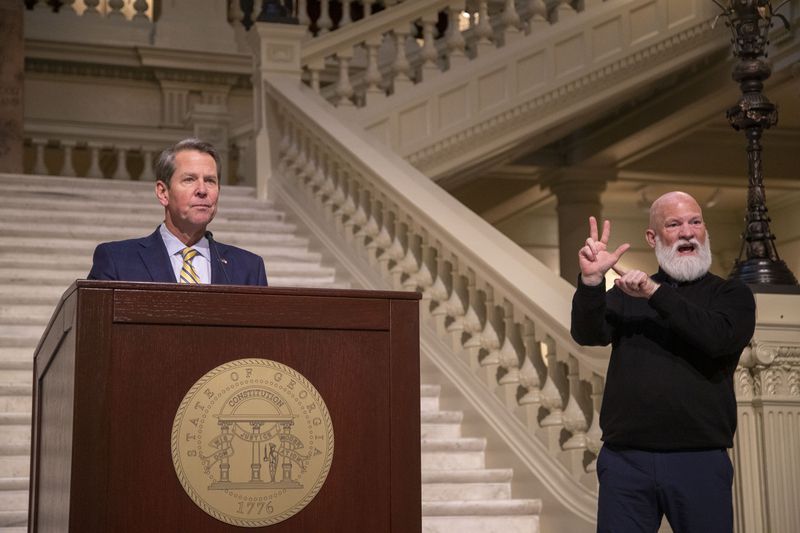 David Cowan, right, interprets as Gov. Brian Kemp gives remarks during a COVID-19 update press conference in January 2021. (Alyssa Pointer / Alyssa.Pointer@ajc.com)