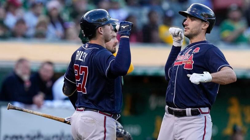 Atlanta Braves' Matt Olson, right, celebrates with Austin Riley, left, after hitting a solo home run against the Oakland Athletics during the eighth inning of a baseball game in Oakland, Calif., Monday, May 29, 2023. (AP Photo/Godofredo A. Vásquez)