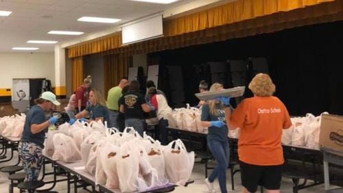 Chattahoochee County School District teachers, cafeteria workers and other staffers packaged free meals for delivery to students last spring after schools closed due to COVID-19. CONTRIBUTED
