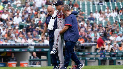 Atlanta Braves relief pitcher Jesse Chavez (60) is helped off the field after being hit by a Detroit Tigers' Miguel Cabrera ground ball in the sixth inning during the first baseball game of a doubleheader, Wednesday, June 14, 2023, in Detroit. (AP Photo/Paul Sancya)