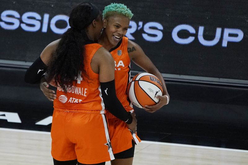 Team WNBA's Arike Ogunbowale, left, and Courtney Williams celerate after defeating United States in a WNBA All-Star basketball game, Wednesday, July 14, 2021, in Las Vegas. (AP Photo/John Locher)