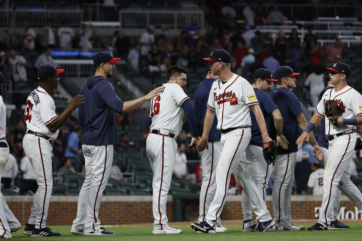 Braves players celebrate their win after defeating the Colorado Rockies 8-3 at Truist Park. Miguel Martinez / miguel.martinezjimenez@ajc.com 