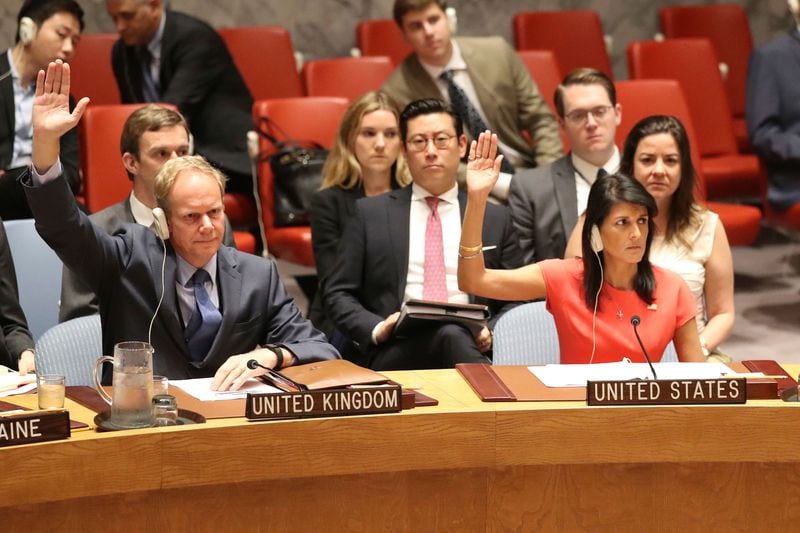 British Ambassador to the United Nations Matthew Rycroft, left, and American Ambassador to the United Nations Nikki Haley vote during a Security Council meeting on a new sanctions resolution that would increase economic pressure on North Korea to return to negotiations on its missile program, Aug. 5, 2017. (The Associated Press)