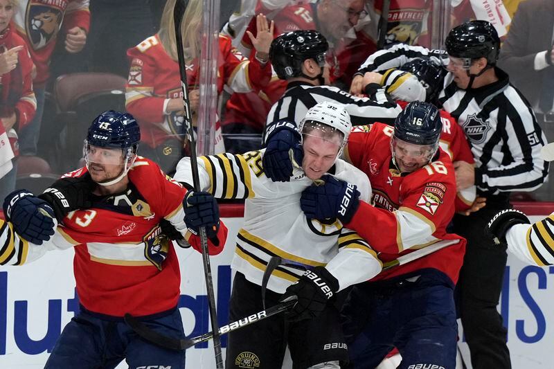Florida Panthers center Sam Reinhart (13), Boston Bruins center Morgan Geekie, center, and Panthers center Aleksander Barkov (16) get into a scuffle during the third period of Game 2 of a second-round series of the NHL hockey Stanley Cup playoffs Wednesday, May 8, 2024, in Sunrise, Fla. (AP Photo/Lynne Sladky)