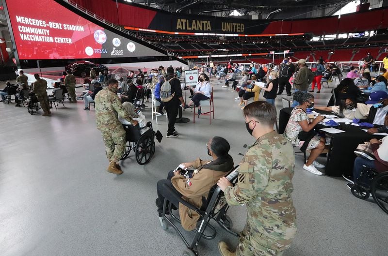 032421 Atlanta: U.S. Army soldiers from Fort Stewart help some of the elderly through the process of getting their first vaccination at Mercedes-Benz Stadium, the state’s largest Community Vaccination Center on Wednesday, March 24, 2021, in Atlanta.  “Curtis Compton / Curtis.Compton@ajc.com”