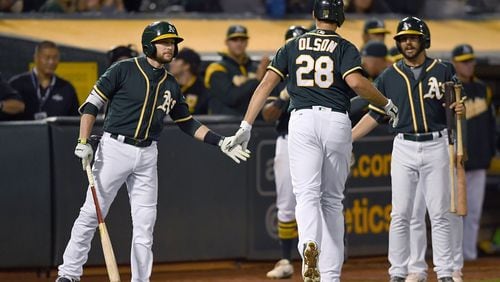 OAKLAND, CA - JUNE 30:  Matt Olson #28 of the Oakland Athletics is congratulated by Jed Lowrie #8 after Olson broke up a no-hitter with a solo home run against the Atlanta Braves in the bottom of the ninth inning at Oakland Alameda Coliseum on June 30, 2017 in Oakland, California. The Braves won the game 3-1. (Photo by Thearon W. Henderson/Getty Images)