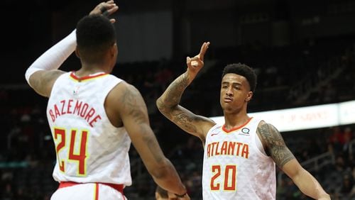 Hawks forward John Collins reacts when Kent Bazemore hits a three pointer against the Utah Jazz during a 104-90 victory in a NBA basketball game on Monday, January 22, 2018, in Atlanta.   Curtis Compton/ccompton@ajc.com