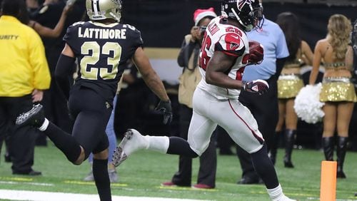 Falcons running back Tevin Coleman scores the Falcons' only touchdown against the Saints during the second half in a NFL football game on Sunday, December 24, 2017, in New Orleans.   Curtis Compton/ccompton@ajc.com