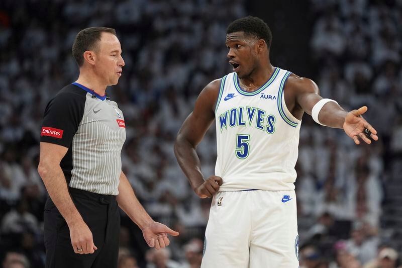 Minnesota Timberwolves guard Anthony Edwards (5) talks with referee Josh Tiven during the first half of Game 2 of the team's NBA basketball first-round playoff series against the Phoenix Suns, Tuesday, April 23, 2024, in Minneapolis. (AP Photo/Abbie Parr)