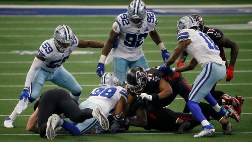 Dallas' Justin March (59) and Dorance Armstrong (92) look on as C.J. Goodwin (29) recovers an onside kick against the Falcons late in the game Sunday, Sept. 20, 2020, in Arlington, Texas. (Ron Jenkins/AP)