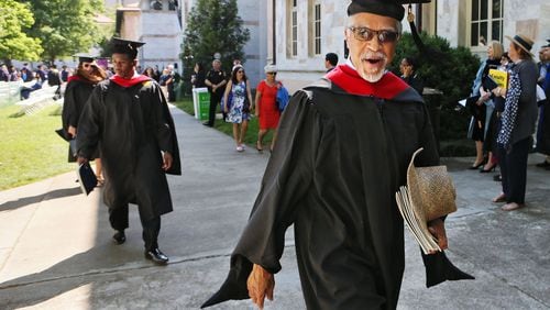 Hurl Taylor, 77, walks out with a big smile during the recessional on May 9. Decades after graduating from Emory Law, he received a master’s degree from Candler School of Theology to support his prison ministry. BOB ANDRES / BANDRES@AJC.COM