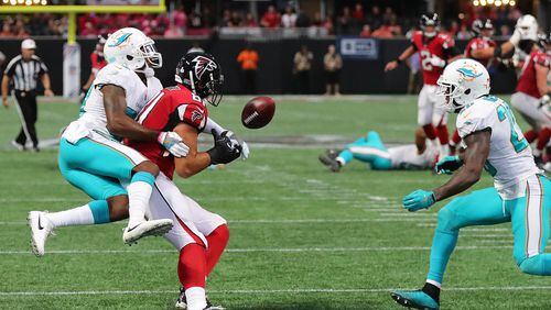 Dolphins cornerback Cordrea Tankersley knocks the ball away from Falcons tight end Austin Hooper and into the arms of Dolphins safety Reshad Jones in the final minute of the Falcons' 20-17 loss at home Oct. 15. Curtis Compton/ccompton@ajc.com.