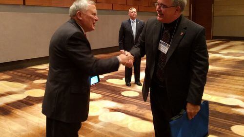 Gov. Nathan Deal shakes hands with Georgia School Superintendent Richard Woods. AJC file.