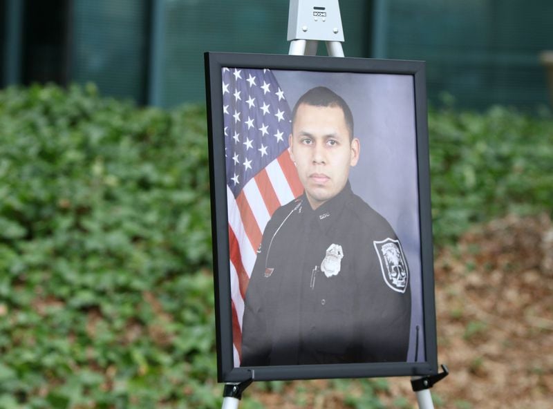 3/13/19 - Tucker - A photo of DeKalb County Officer Edgar Isidro Flores, who died in the line of duty in December, is displayed at DeKalb County police headquarters in Tucker, Georgia on Wednesday, March 13, 2019. DeKalb County police K-9 Indi will return to work after being shot and losing an eye while helping human police officers track down Flores’ killer. EMILY HANEY / emily.haney@ajc.com
