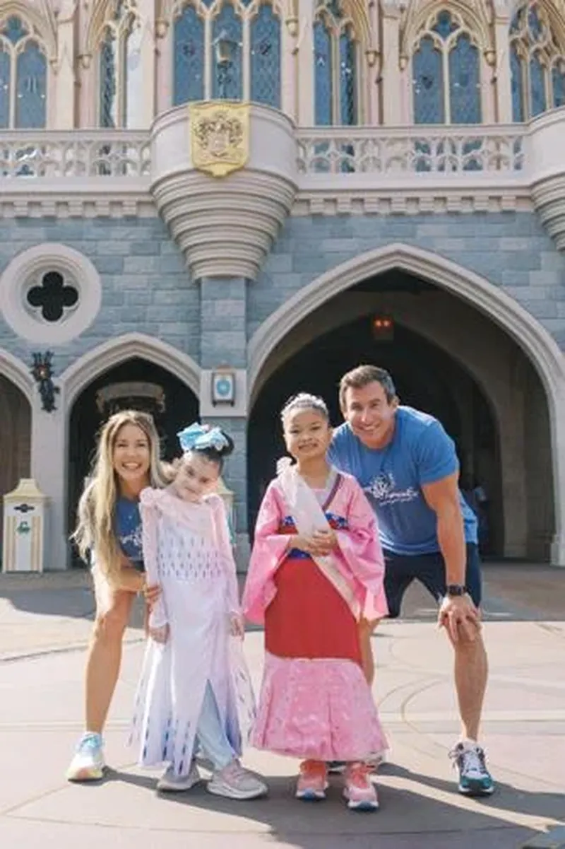 From left, "The Bert Show" member Kristin Klinghorn, Dakota, Layla and Bert Weiss pose before the castle at Disney's Magic Kingdom. (Courtesy of Bert's Big Adventure)