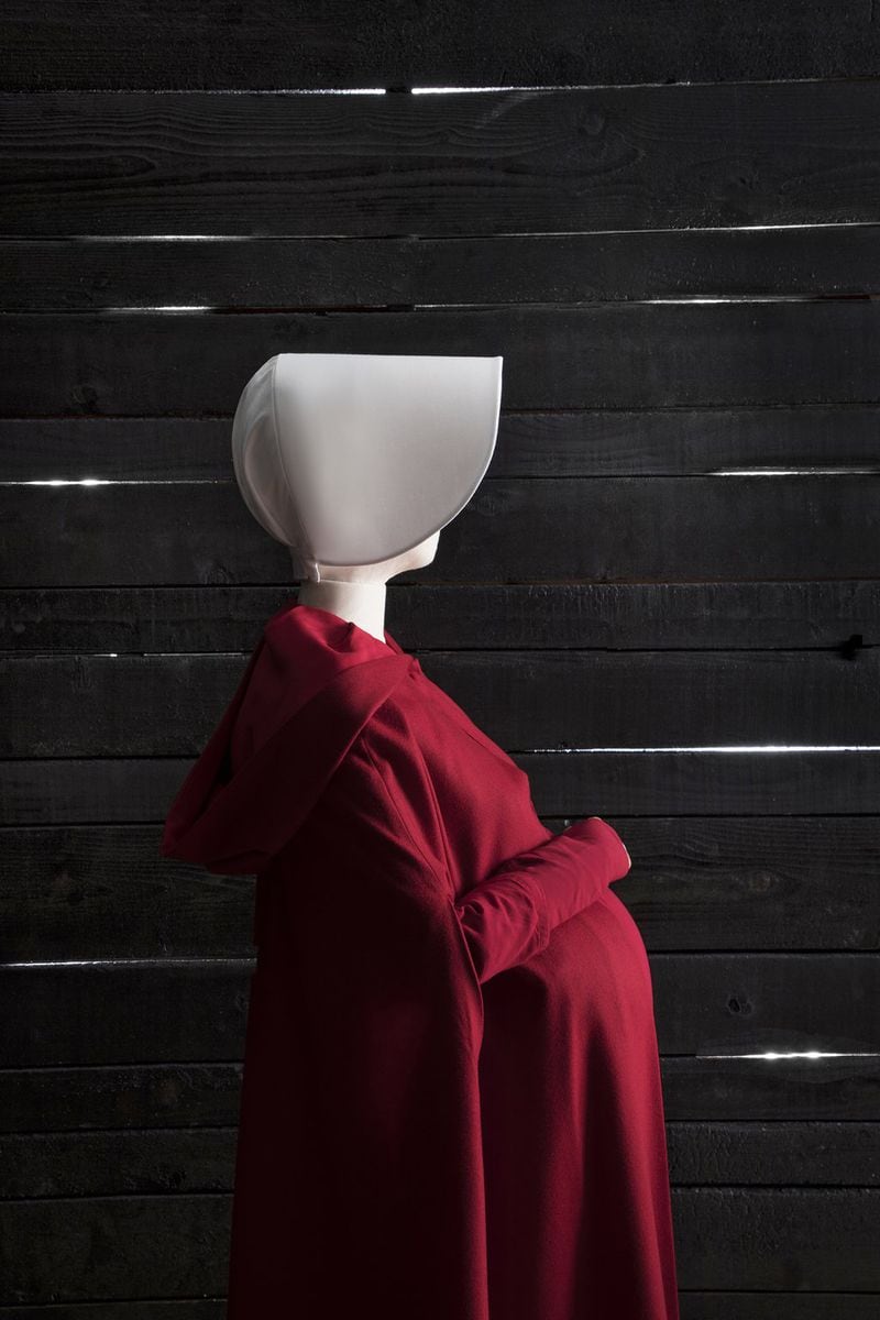 Costumes from the Hulu series “The Handmaid’s Tale,” based on Margaret Atwood’s novel, are featured in an exhibition at SCAD FASH Museum of Fashion + Film. CONTRIBUTED BY CHIA CHONG / SCAD FASH MUSEUM OF FASHION + FILM