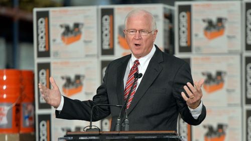 October 8, 2014 Locust Grove - Senator Saxby Chambliss speaks during a cost-sharing agreement event for the Savannah Harbor Expansion Project at Home Depot Direct Fulfillment Center on Wednesday, October 8, 2014. Gov. Nathan Deal announced that the U.S. Army Corps of Engineers, the Georgia Department of Transportation and the Georgia Ports Authority have signed a cost-sharing agreement for the Savannah Harbor Expansion Project, meaning dredging in the river could begin by the end of the year. HYOSUB SHIN / HSHIN@AJC.COM Saxby Chambliss speaks in Locust Grove in October. (AJC/Hyosub Shin)