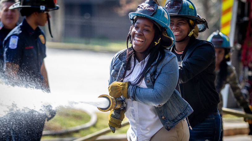Therrell High School senior Dayssia Dugger (C) participates in the Atlanta Fire departments Delayed Entry Program training at her high school Thursday, March 21, 2019.  STEVE SCHAEFER / SPECIAL TO THE AJC