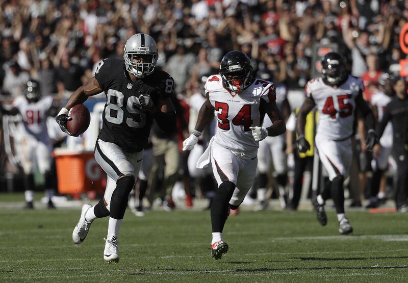 Oakland Raiders wide receiver Amari Cooper (89) runs in front of Atlanta Falcons defensive back Brian Poole (34) during the second half of an NFL football game in Oakland, Calif., Sunday, Sept. 18, 2016. The play was called back on a penalty. (AP Photo/Marcio Jose Sanchez)