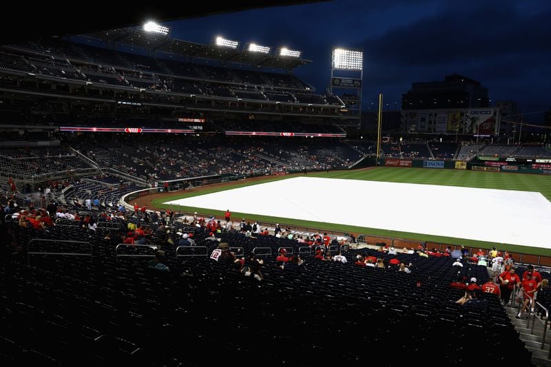 WASHINGTON, DC - JULY 06:  Fans wait out the rain delayed start of the Washington Nationals and Atlanta Braves game at Nationals Park on July 6, 2017 in Washington, DC.  (Photo by Rob Carr/Getty Images)