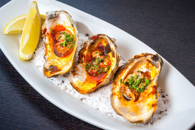 The grilled oysters with lemon butter and smoked paprika at Simon’s Restaurant in Midtown didn’t please our reviewer. CONTRIBUTED BY CHRISTOPHER WATKINS