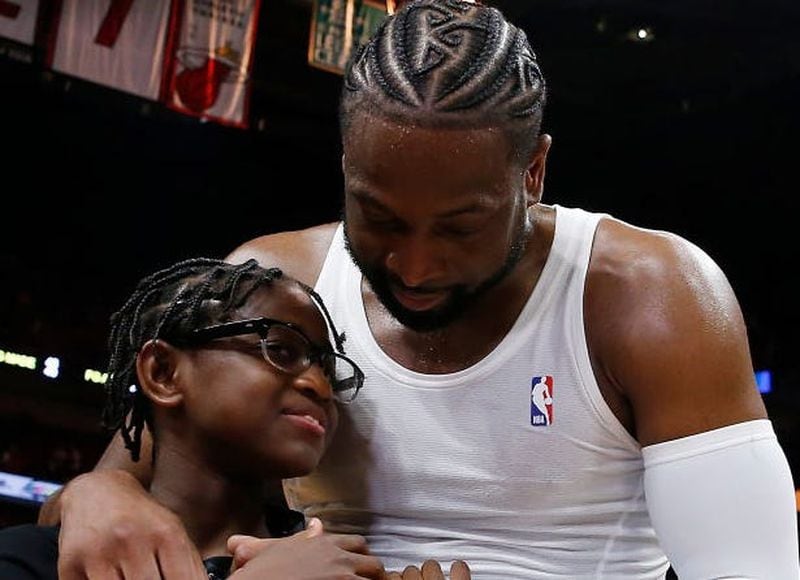 Dwyane Wade hugs his daughter, Zaya, after his final career home game at AmericanAirlines Arena on April 9, 2019, in Miami.