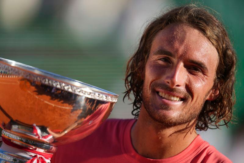Stefanos Tsitsipas of Greece poses with the trophy after defeating Casper Ruud of Norway to win the Monte Carlo Tennis Masters final match 6-1, 6-4 in Monaco, Sunday, April 14, 2024. (AP Photo/Daniel Cole)