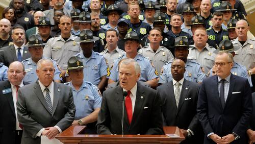 Gov. Nathan Deal proposed Thursday a 20 percent pay hike for state law enforcement officers and an overhaul of police training to include more courses on use of force and community policing. BOB ANDRES /BANDRES@AJC.COM