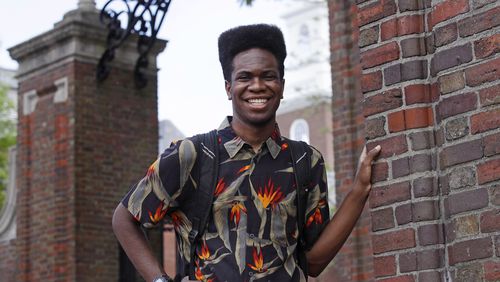 Obasi Shaw poses outside the gates of Harvard Yard in Cambridge, Mass., Thursday, May 18, 2017. Shaw, an English major who graduates from Harvard next week, is the university's first student to submit his final thesis in the form of a rap album. The record, called â€œLiminal Minds,â€ has earned the equivalent of an A- grade, good enough to ensure that Shaw will graduate with honors at the universityâ€™s commencement next week. (AP Photo/Charles Krupa)