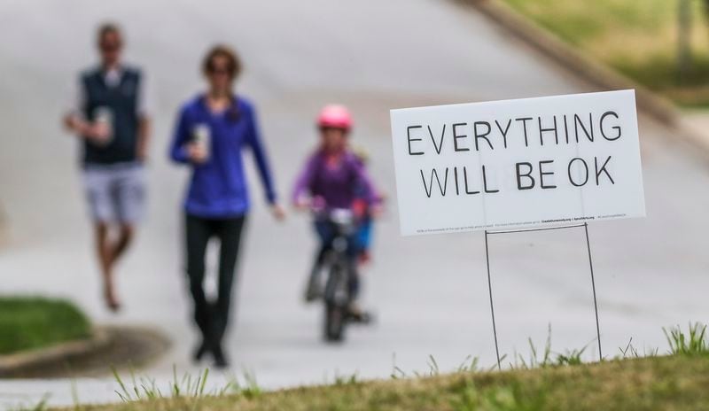 March 26, 2020 Dunwoody: Left to right - Matt Blackburn, Shannon Blackburn, Jackson-4 and Henley-7 walked past one of several "Everything will be OK" yard signs along Trailridge Lane in Dunwoody where a group called CREATE Dunwoody a non profit raising money from the sales of the yard signs that will help raise much needed funds for artists and art teachers that are impacted financially during the crisis. The profits will go to local artists and art teachers Ã¬who have been financially impacted from gallery, studio and school closings due to coronavirus,Ã® according to Create Dunwoody, an organization that promotes the arts in Dunwoody. The impact of the coronavirus in Georgia was evident everywhere on Thursday, March 26, 2020 - from less traveled streets, public service billboards and people staying home. Dr. Kathleen Toomey, the state public health commissioner, says the State of Georgia has several âÃÃºhotspotsâÃÃ¹ of outbreaks, including in Albany, Bartow County, Dublin and Rome. In âÃÃºvirtually all these cases,âÃÃ¹ at least some of the spread was linked to âÃÃºlarge church services,âÃÃ¹ she said. In Dougherty County, for instance, the coronavirus outbreak has been traced to two funeral services in late February and early March. Toomey told clergy that churches, synagogues and mosques that have the technical capacity to offer online services should do so. âÃÃºThis is a short period of inconvenience and worry, but if we invest in this collectively as a community we can help stop this virus,âÃÃ¹ she said. JOHN SPINK/JSPINK@AJC.COM