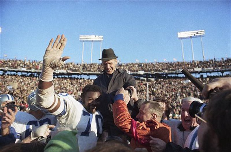 Coach Tom Landry of the Dallas Cowboys is carried from the field by his players after they defeated Miami, 24-3, to win the Super Bowl, Jan. 16, 1972, in New Orleans. Rayfield Wright (70) helps carry Landry. (AP Photo)