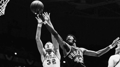 In this Oct. 22, 1969, photo, Connie Hawkins (right) of the Phoenix Suns goes to the basket past Billy Cunningham of the Philadelphia 76ers. (AP Photo/Rusty Kennedy, File)