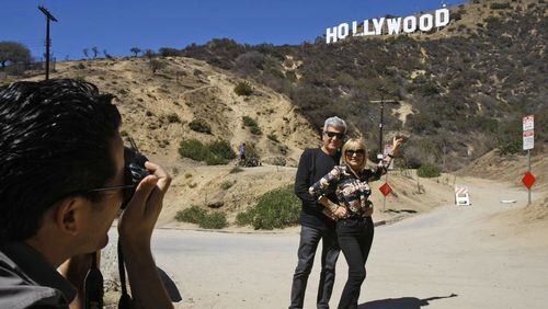 Silvestre Llobet and his wife, Elena Domenech, are photographed by their son, Alejandro Llobet, left, under the Hollywood sign on September 26, 2013, in the Beachwood Canyon area of Los Angeles, Calif. (Gary Friedman/Los Angeles Times/TNS)