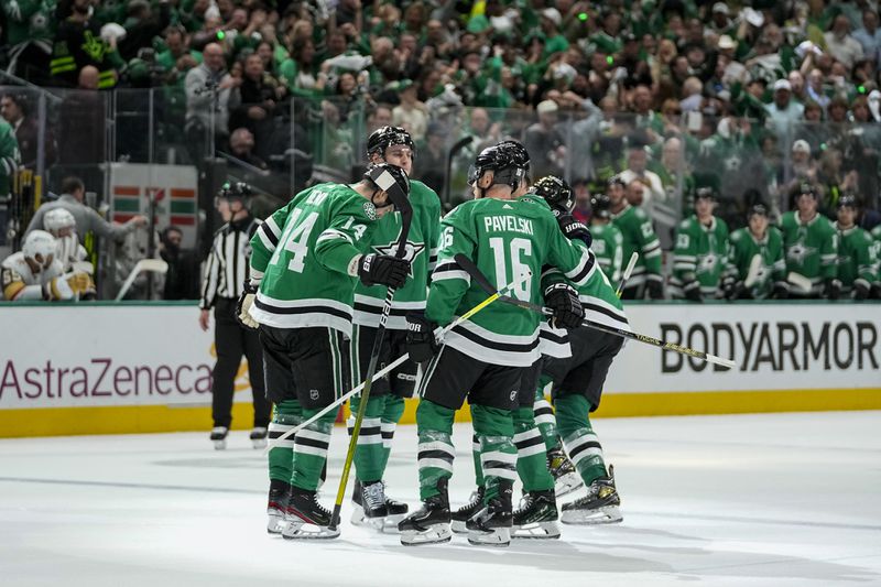 Dallas Stars players celebrate a first period power play goal by Jason Robertson, not visible, during Game 2 of an NHL hockey Stanley Cup first-round playoff series against the Vegas Golden Knights in Dallas, Wednesday, April 24, 2024. (AP Photo/Tony Gutierrez)