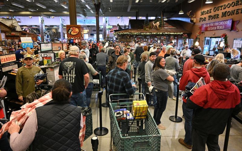 Black Friday shoppers stand in line to check out at the Bass Pro Shops at Sugarloaf Mills in Lawrenceville on Friday, November 25, 2022. (Photo: Hyosub Shin / Hyosub.Shin@ajc.com)