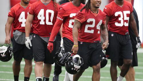 May 22, 2018 Flowery Branch: Atlanta Falcons offensive players Demario Richard (from left), Daniel Marx, Tevin Coleman, Devonta Freeman, and Malik Williams head to the next drill during organized team activities on Tuesday, May 22, 2018, in Flowery Branch.   Curtis Compton/ccompton@ajc.com