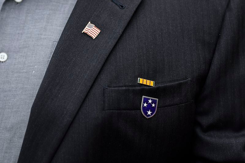 U.S. veteran Dan Hydrick wears a U.S flag pin, a Vietnam service pin, and an Americal Division pin on his jacket on Wednesday, November 2, 2022. (Natrice Miller/natrice.miller@ajc.com)  