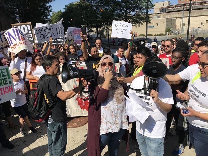 Aisha Yaqoob (center, with microphone) was among hundreds of activists who demonstrated outside the Atlanta City Detention Center on September 4, 2017. 