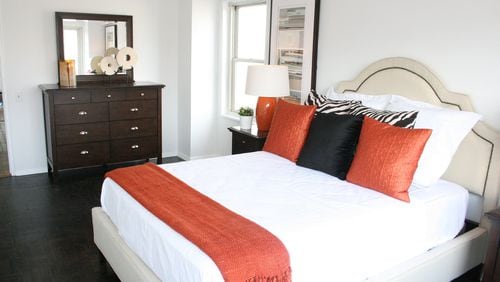 A warm tone of orange helps make this bedroom feel brighter. (Design Recipes)