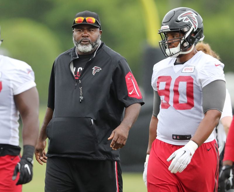 Falcons defensive line coach Bryan Cox works with players during practice at training camp in Flowery Branch. (Curtis Compton / ccompton@ajc.com)