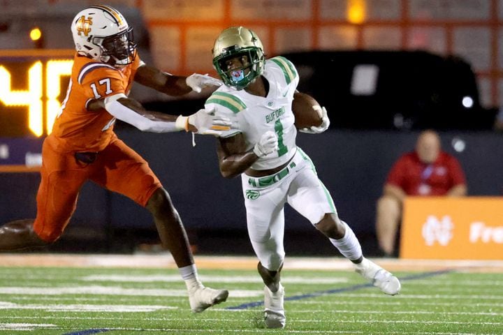August 20, 2021 - Kennesaw, Ga: Buford wide receiver Isaiah Bond (1) runs after a catch against North Cobb linebacker Joshua Josephs (17) during the first half at North Cobb high school Friday, August 20, 2021 in Kennesaw, Ga.. JASON GETZ FOR THE ATLANTA JOURNAL-CONSTITUTION