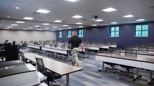 Sgt. James Harkins walks into a scenario training classroom for recruits inside of the new wing of The Gwinnett County Police Training Center on Monday, July 31, 2023. The training center’s new wing also includes a multipurpose room and new locker rooms. (Natrice Miller/ natrice.miller@ajc.com)